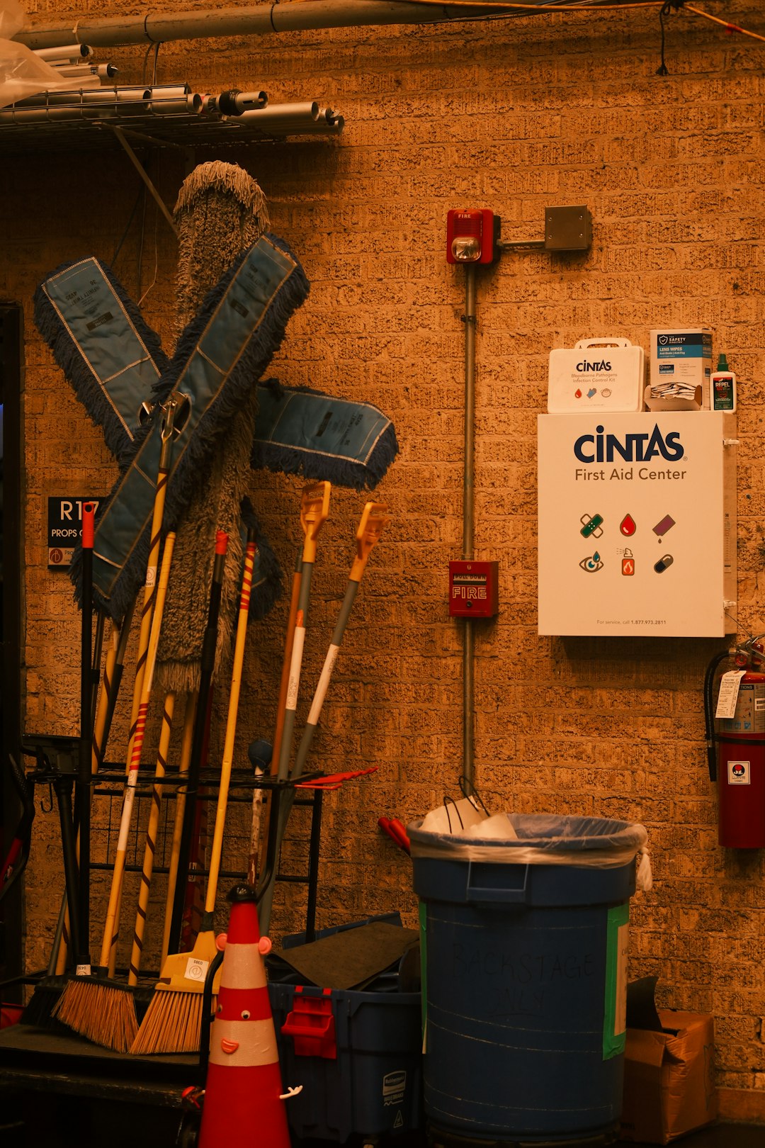 cleaning-supplies-and-first-aid-kit-on-brick-wall-efffdyysjs8